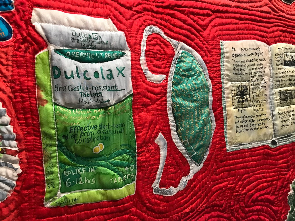 Blood Sweat and Tears, the Menopause Quilt. Detail, featuring objects associated with the menopause, representing insomnia, constipation, creativity. 