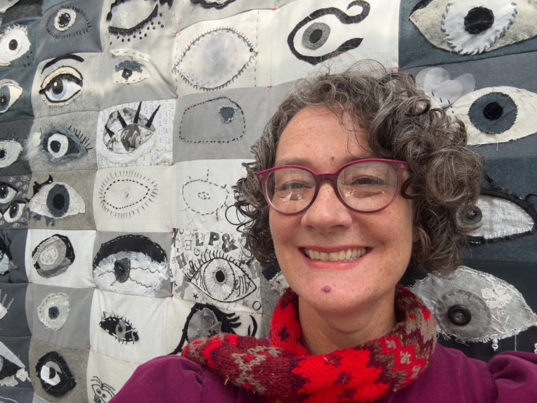 Artist Lois Blackburn with I SEE you quilt