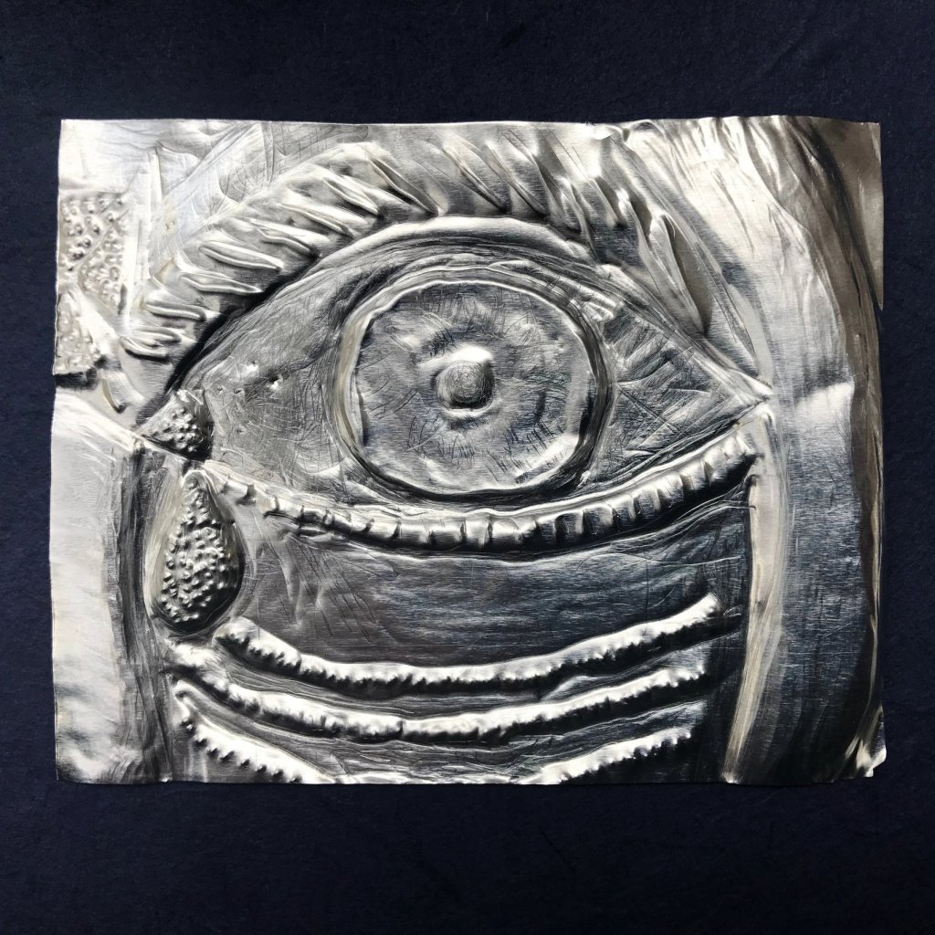 Evil eye amulet, made from embossed metal, staring eye, with tear drop. Symbolic of recovery