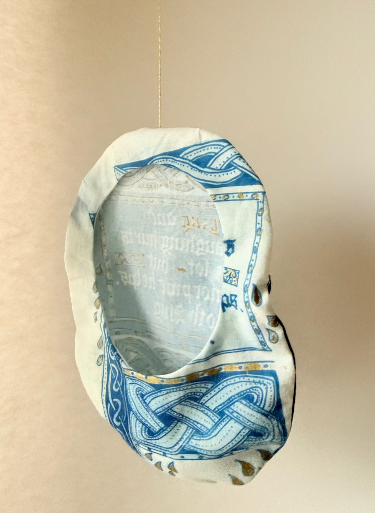 Artist Lois Blackburn's Stoma Bag Cover, Reverse. illustrated with Celtic knots. Cyanotype on cotton fabric.