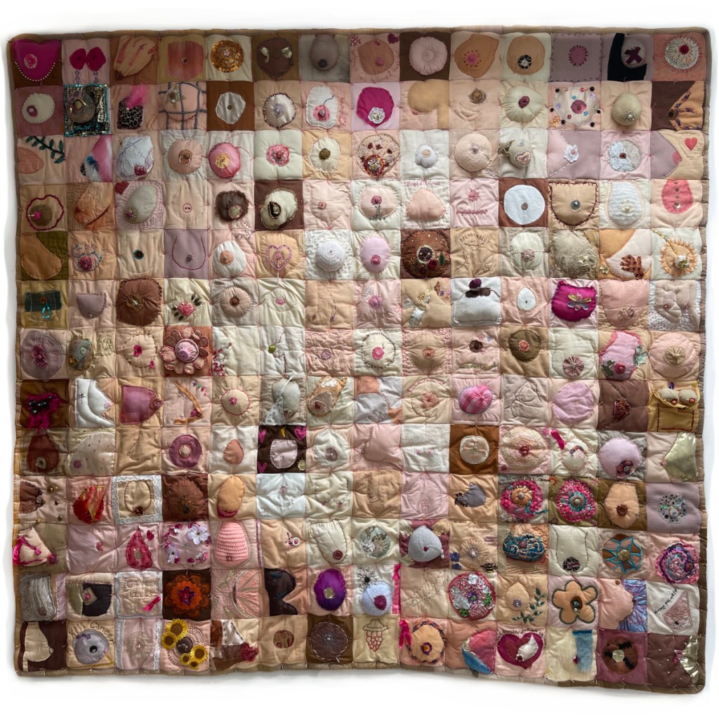 Large quilt, made up of over 100 embroidered breasts of every shape, size and colour.