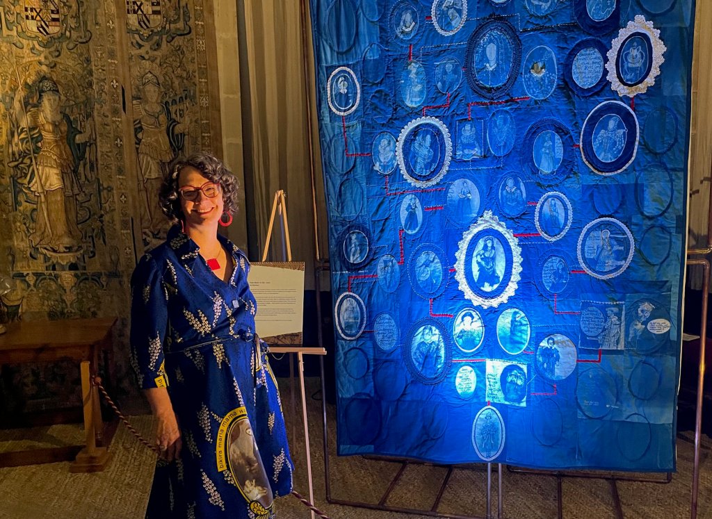 Artist Lois Blackburn stood next to her art quilt From Roots to the Sky, part of the exhibition Material Matters at Hardwick Hall.
