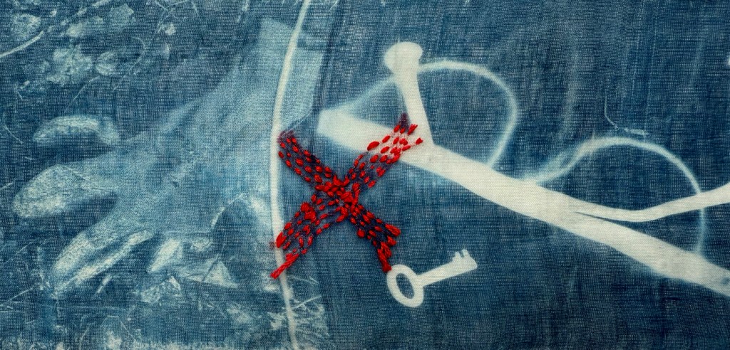 Embroidered cyanotype on fabric sample.  Part of Lost then Found series by Lois Blackburn. Picturing glasses, glove and keys