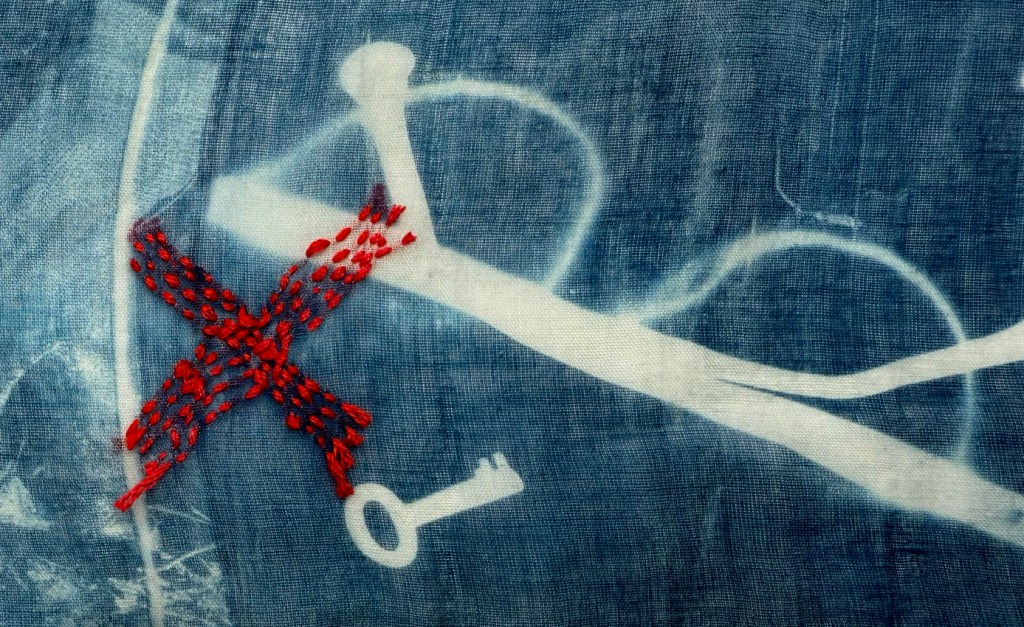 Embroidered cyanotype on fabric sample. Part of Lost then Found series by Lois Blackburn. Picturing glasses, glove and keys